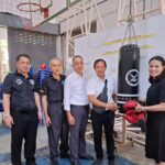 Pa Mok Municipality mayor Police Colonel Ronakorn Wongphumani (center) and executive committee members present Muay Thai training equipment to Pa Mok Community School at Wat Pa Mok on January 20, 2026, including a heavy bag, boxing gloves, and training gear to support youth sports development and keep students away from drugs.